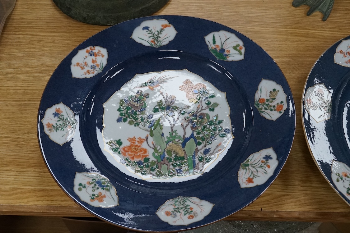 A near pair of Samson famille verte powder blue dishes in Chinese export style, each painted with a pheasant flying above blossoming branches and rocks, the border set with eight floral cartouches, underglaze blue ribbon